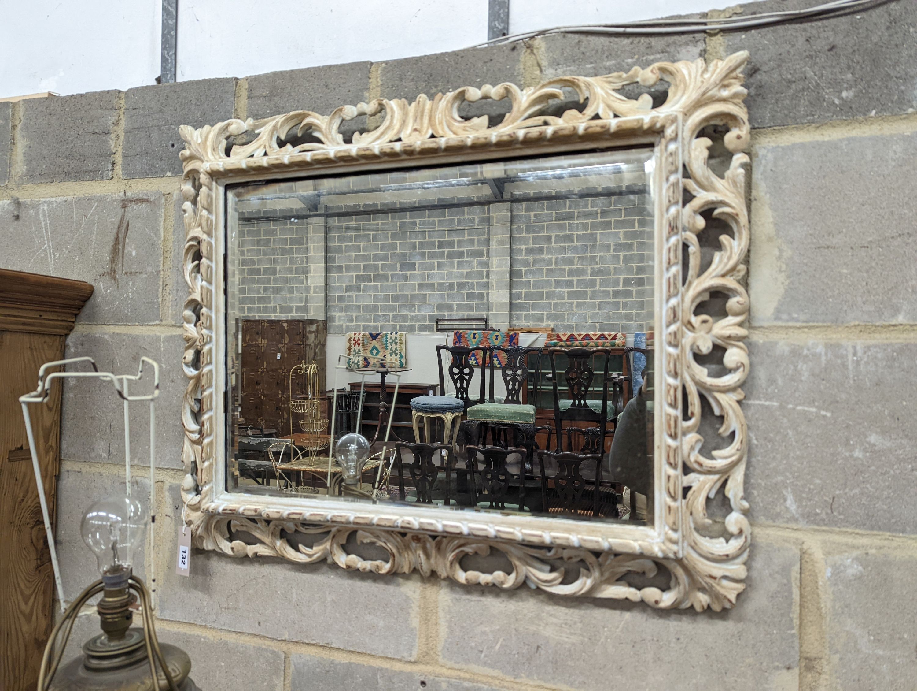 A painted rectangular pierced pine wall mirror, width 78cm, height 64cm